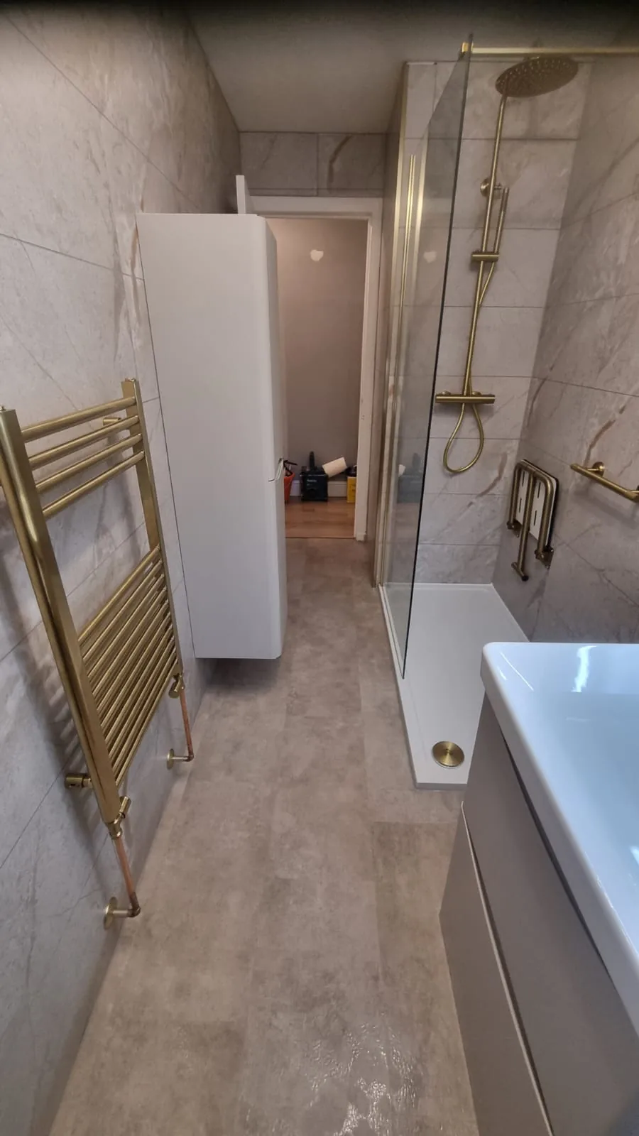 Narrow shower room with brass fittings and tall storage